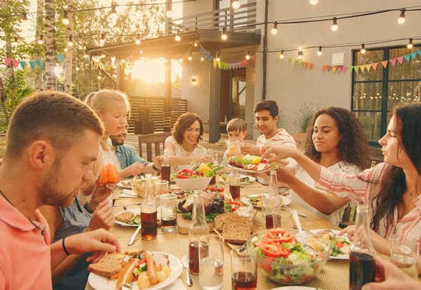 Family-Friends-Food-Party-1024x706-res People eating food at a table outside